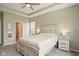 Relaxing primary bedroom showcasing a ceiling fan, natural light, plush carpet, and a rustic farmhouse-style bed at 4367 Homestead Dr, Whitestown, IN 46075