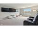 Spacious entertainment room includes large wall-mounted TVs, neutral carpet, and comfortable seating at 4367 Homestead Dr, Whitestown, IN 46075