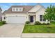 Inviting home showcasing a lush front lawn, attached garage, and a classic front door at 4367 Homestead Dr, Whitestown, IN 46075