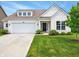 Charming home featuring a well-maintained lawn, attached garage, and inviting front entrance at 4367 Homestead Dr, Whitestown, IN 46075