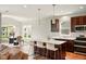 Open-concept kitchen featuring an island, pendant lighting, and modern appliances, flowing to a dining area at 4367 Homestead Dr, Whitestown, IN 46075