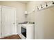 Bright laundry room featuring a white washer and dryer, wire shelving, and a convenient row of hooks at 4367 Homestead Dr, Whitestown, IN 46075