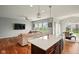 Open concept living space with kitchen island and comfortable sectional sofa at 4367 Homestead Dr, Whitestown, IN 46075