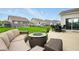 Inviting patio with a cozy seating area, a modern fire pit table, and landscaped surroundings at 4367 Homestead Dr, Whitestown, IN 46075