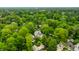 Aerial view showcases the property nestled among lush trees within a tranquil, established neighborhood at 4410 N Pennsylvania St, Indianapolis, IN 46205