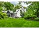 Lush backyard featuring a well-maintained lawn, patio area, and mature trees, offering a private outdoor retreat at 4410 N Pennsylvania St, Indianapolis, IN 46205