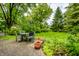 Charming backyard patio with outdoor seating, surrounded by lush greenery and garden beds for serene enjoyment at 4410 N Pennsylvania St, Indianapolis, IN 46205