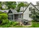 Charming backyard patio with outdoor seating surrounded by lush landscaping and a screened-in porch at 4410 N Pennsylvania St, Indianapolis, IN 46205