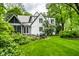 Beautiful backyard showcasing a green lawn, manicured landscaping, and a patio for outdoor entertainment and relaxation at 4410 N Pennsylvania St, Indianapolis, IN 46205
