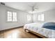 Bright bedroom with multiple windows, wood floors, ceiling fan, and neutral decor at 4410 N Pennsylvania St, Indianapolis, IN 46205