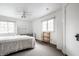 Bedroom featuring two windows, a ceiling fan, an attached desk, a bed, and a wooden shelf at 4410 N Pennsylvania St, Indianapolis, IN 46205