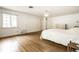 Bright, minimalist bedroom with hardwood floors, white walls, and a view of the outdoors at 4410 N Pennsylvania St, Indianapolis, IN 46205