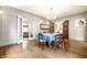 Elegant dining room featuring hardwood floors, chandelier, and access to a sunroom through french doors at 4410 N Pennsylvania St, Indianapolis, IN 46205