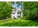 Charming white two-story home surrounded by lush green lawn and mature trees at 4410 N Pennsylvania St, Indianapolis, IN 46205
