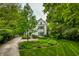 Charming two-story home with intricate architectural details and lush landscaping at 4410 N Pennsylvania St, Indianapolis, IN 46205