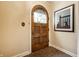 Classic arched front door with decorative glass and a patterned tile floor at 4410 N Pennsylvania St, Indianapolis, IN 46205