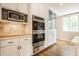 Bright kitchen features white cabinets, stainless steel appliances, and a built-in microwave at 4410 N Pennsylvania St, Indianapolis, IN 46205