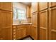 Bright kitchen with wood cabinets, a sink, and a window at 4410 N Pennsylvania St, Indianapolis, IN 46205