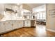 Bright, open kitchen with white cabinets, stainless steel appliances and hardwood floors at 4410 N Pennsylvania St, Indianapolis, IN 46205