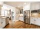 Bright, open kitchen with white cabinets, stainless steel appliances and hardwood floors at 4410 N Pennsylvania St, Indianapolis, IN 46205