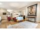 Spacious living room with hardwood floors, a rug, a sofa, and brick painted white at 4410 N Pennsylvania St, Indianapolis, IN 46205