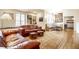 Cozy living room with hardwood floors, a sofa, an area rug, and a dining area at 4410 N Pennsylvania St, Indianapolis, IN 46205