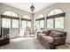 Bright sun room with arched windows, white brick, neutral carpet and a comfortable seating area at 4410 N Pennsylvania St, Indianapolis, IN 46205