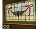 Close up of a stained glass window with grapes and bows at 4410 N Pennsylvania St, Indianapolis, IN 46205
