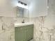 Chic bathroom featuring a green vanity, modern fixtures, and elegant marble-patterned tile at 453 Illinois St, Fortville, IN 46040