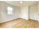 Charming bedroom with closet, neutral walls, light wood-look flooring, and ample natural light at 453 Illinois St, Fortville, IN 46040
