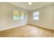 Bright bedroom featuring two windows with natural light, and wood-look flooring at 453 Illinois St, Fortville, IN 46040