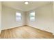 Cozy bedroom with wood-look floors, neutral walls, and great natural light from two windows at 453 Illinois St, Fortville, IN 46040