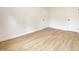 Neutral bedroom featuring wood-look flooring and multiple closets or doors at 453 Illinois St, Fortville, IN 46040
