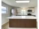 Open-concept kitchen with stainless steel appliances, custom island, and ample counter space at 453 Illinois St, Fortville, IN 46040