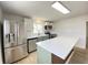 Well-lit kitchen with a modern island, stainless steel appliances, and stylish cabinetry at 453 Illinois St, Fortville, IN 46040