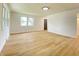 Open living area with sleek wood-look flooring, neutral walls, and abundant natural light at 453 Illinois St, Fortville, IN 46040