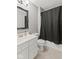 This bathroom features a black shower curtain and elegant framed mirror at 4907 Franklin Villas Pl, Indianapolis, IN 46237