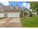 Charming brick home featuring a two-car garage, well-manicured lawn, and inviting curb appeal at 4907 Franklin Villas Pl, Indianapolis, IN 46237