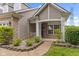 Inviting front porch featuring a small garden with a stone border leading to the front door at 4907 Franklin Villas Pl, Indianapolis, IN 46237