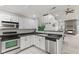 Modern kitchen featuring stainless steel appliances, white cabinetry, and an open design for seamless entertaining at 4907 Franklin Villas Pl, Indianapolis, IN 46237