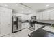 Bright kitchen featuring stainless steel appliances, white cabinets, and tile flooring for a clean and modern look at 4907 Franklin Villas Pl, Indianapolis, IN 46237
