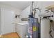 Convenient laundry area with ample storage, a washer/dryer, and water heater at 4907 Franklin Villas Pl, Indianapolis, IN 46237