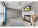 Bright sitting room featuring a fireplace, tile flooring, and a ceiling fan at 4907 Franklin Villas Pl, Indianapolis, IN 46237