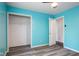 Bedroom with blue accent wall, closet with shelving, and doorway to another room at 522 E County Road 1000 S, Clayton, IN 46118