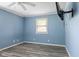 A blue bedroom has a window for natural light and space for creativity at 522 E County Road 1000 S, Clayton, IN 46118