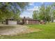Back exterior view of a one-story brick home with an attached garage and large backyard at 522 E County Road 1000 S, Clayton, IN 46118