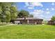Back exterior view of a one-story brick home with an attached garage and large backyard at 522 E County Road 1000 S, Clayton, IN 46118