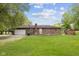 Back exterior view of a one-story brick home with a large backyard at 522 E County Road 1000 S, Clayton, IN 46118