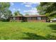 Brick home with well-manicured front lawn, landscaping, and mature trees at 522 E County Road 1000 S, Clayton, IN 46118