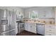 Traditional kitchen features stainless appliances, light cabinets, and tile backsplash at 522 E County Road 1000 S, Clayton, IN 46118